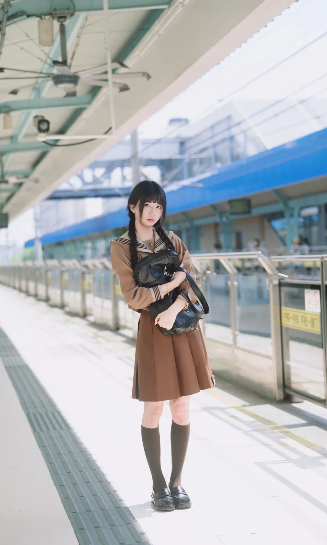 Autumn caramel brown-toned uniform photoshoot: Japanese style photography aesthetics on the station platform - Image 1