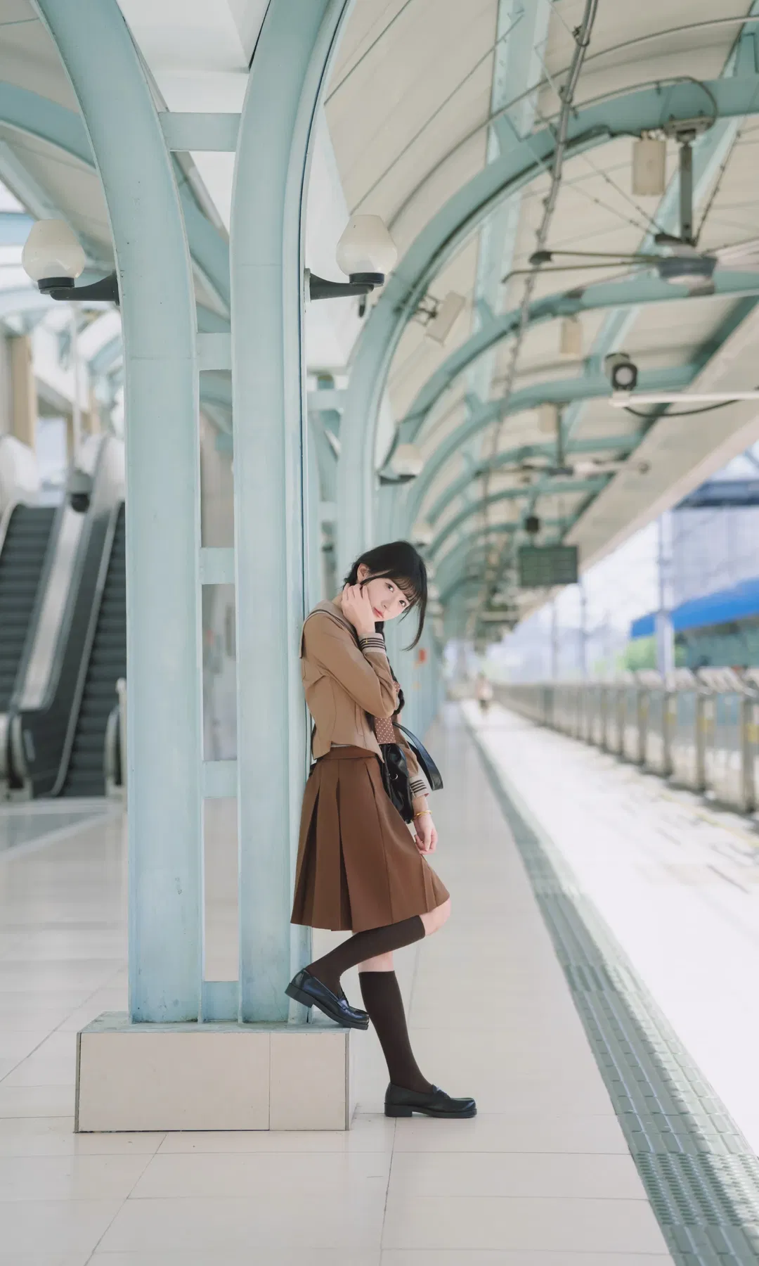 Autumn caramel brown-toned uniform photoshoot: Japanese style photography aesthetics on the station platform - Image 4