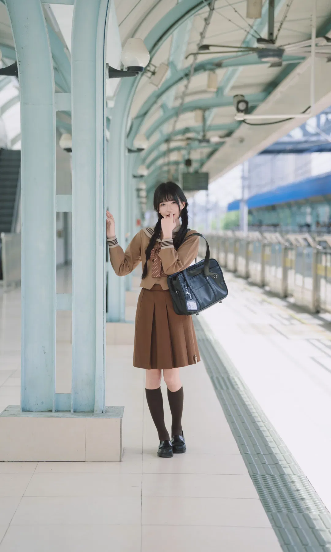 Autumn caramel brown-toned uniform photoshoot: Japanese style photography aesthetics on the station platform - Image 5